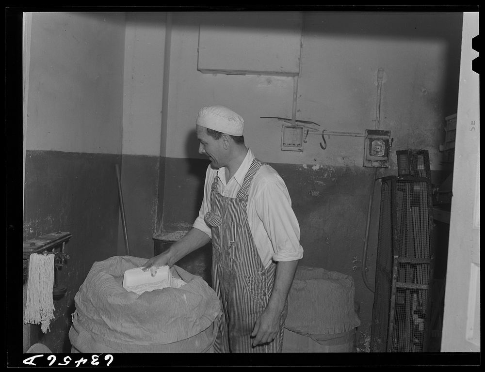 Weighing barrel of powdered milk. Condensary at Antigo, Wisconsin. Sourced from the Library of Congress.