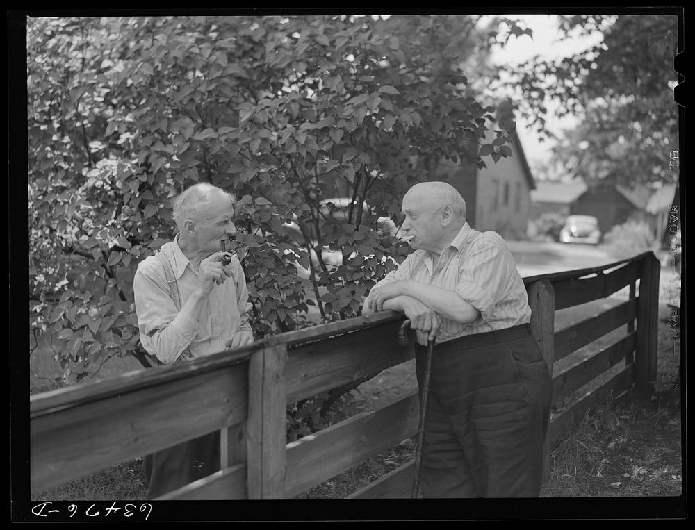 Residents of copper range town talking over back fence. Laurium, Michigan. Sourced from the Library of Congress.