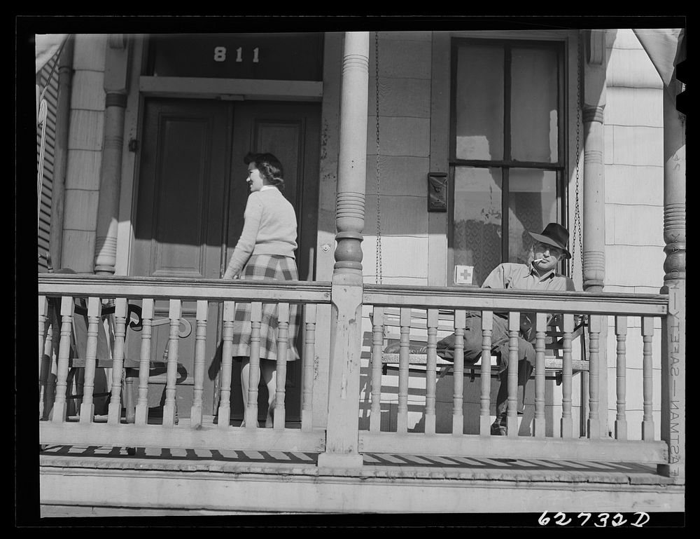 [Untitled photo, possibly related to: Front porch, rooming house. Portsmouth, Virginia]. Sourced from the Library of…