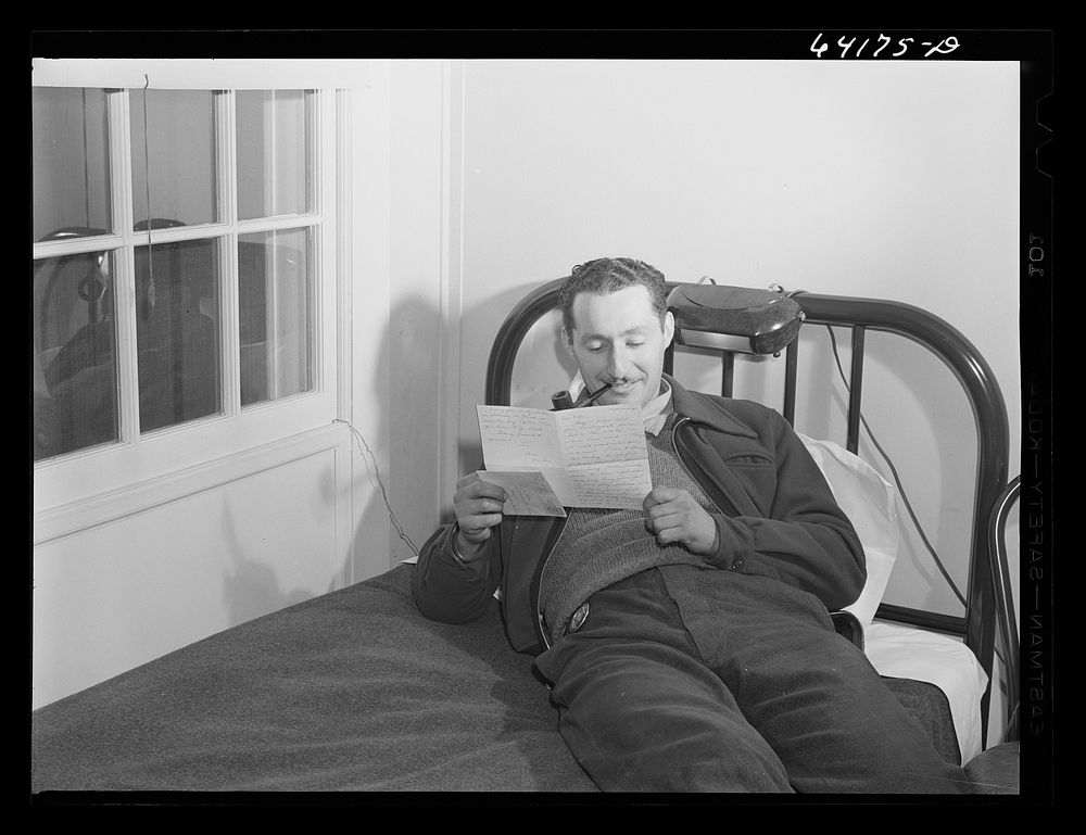 Defense worker reading a letter from home. He works at the proving grounds in Aberdeen, Maryland and lives in one of the FSA…