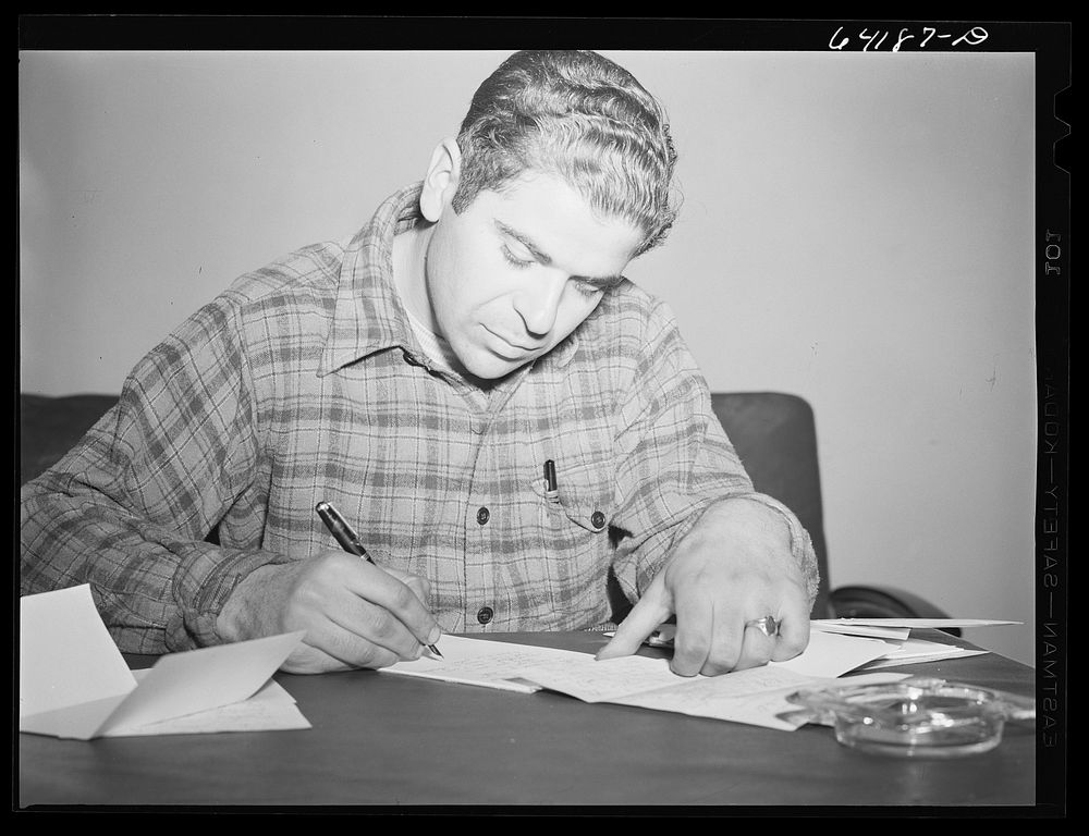 [Untitled photo, possibly related to: Defense worker writing a letter home in lobby of one of the FSA (Farm Security…