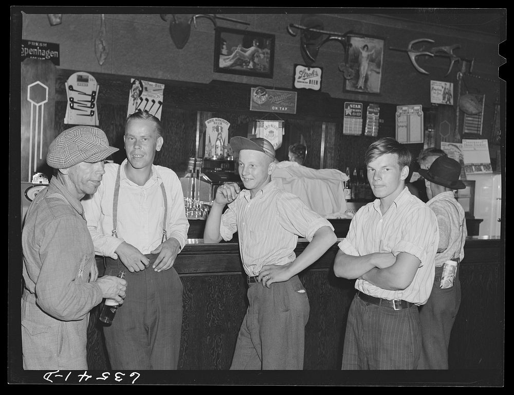 Farm boys in beer parlor on Sunday afternoon. Finnish community of Bruce Crossing, Michigan. Sourced from the Library of…