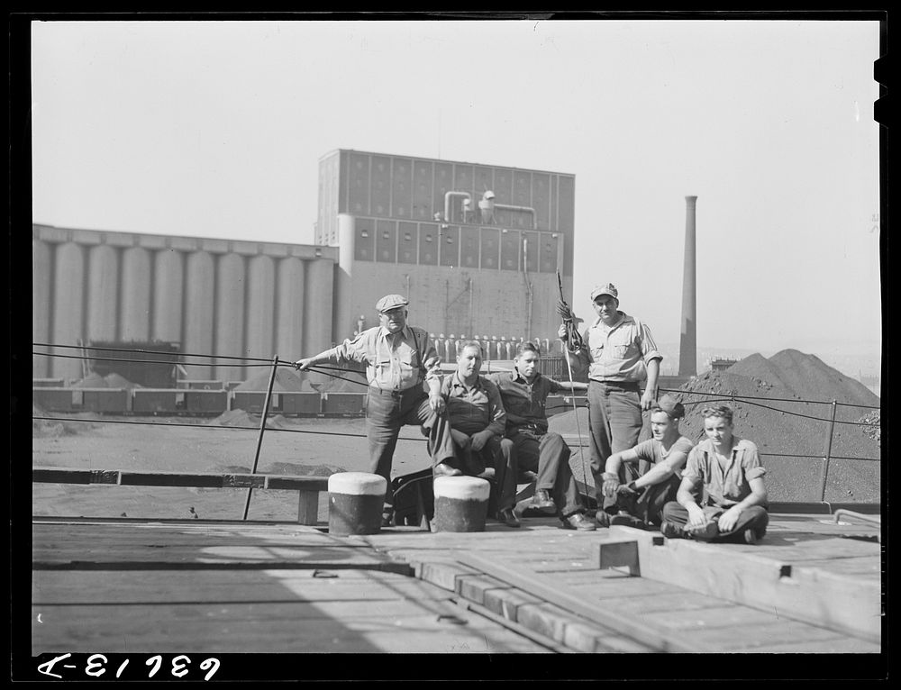 Captain (on the left) and part of the crew of the "James Watt," Great Lakes boat which is being loaded with wheat to take to…