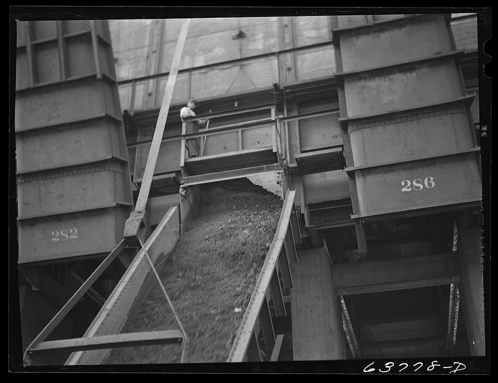 Iron ore going down chute into hold of boat. Allouez, Wisconsin. Sourced from the Library of Congress.