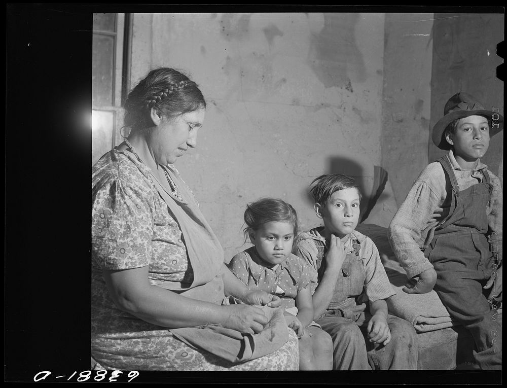 [Untitled photo, possibly related to: Children of Mexican sugar beet workers on porch of one of the houses at Saginaw Farms…