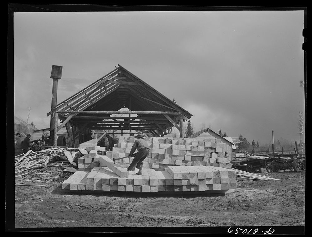 Kalispell, Montana. Flathead Valley special area project. Stacking railroad ties at cooperative sawmill. This sawmill is…