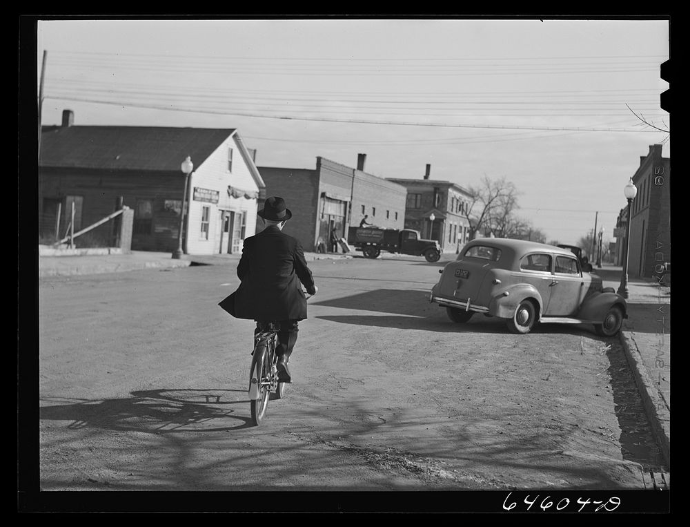 Ipswich, South Dakota. Village priest riding a bicycle to town. Sourced from the Library of Congress.