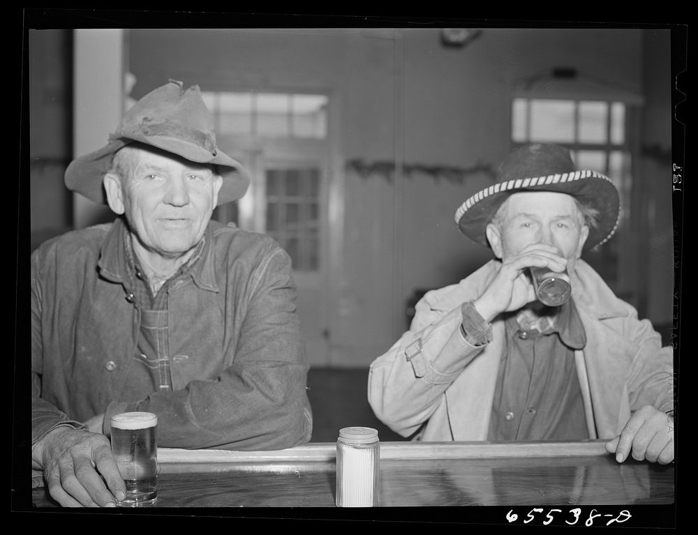 "[Untitled photo, possibly related to:  Hamilton, Montana. Sheep workers at the bar]". Sourced from the Library of Congress.