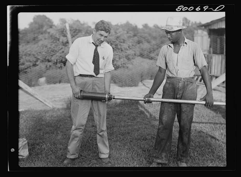 The rod is attached first and then the drop pipe. Safe well demonstration near La Plata, Maryland. Charles County. Sourced…