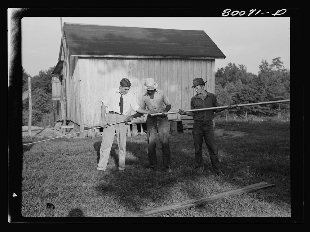Assembling the drop pipe and sucker rod. Safe well demonstration near La Plata, Maryland. Charles County. Sourced from the…