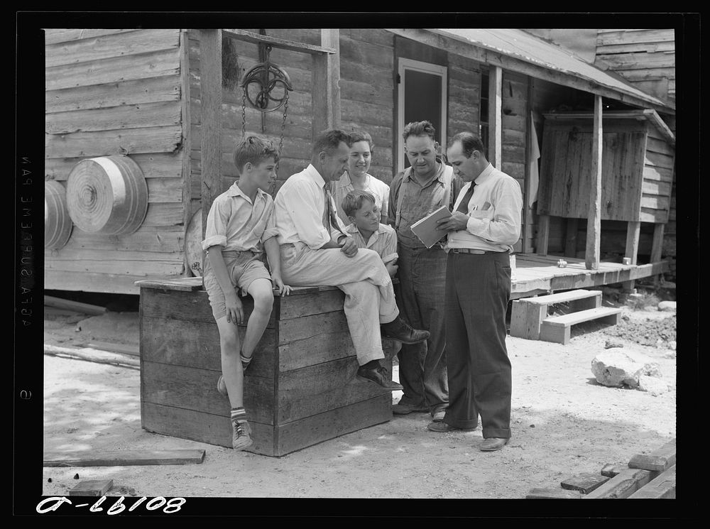 Well engineer and county supervisor talking over home plan. Charles County, Maryland. Sourced from the Library of Congress.