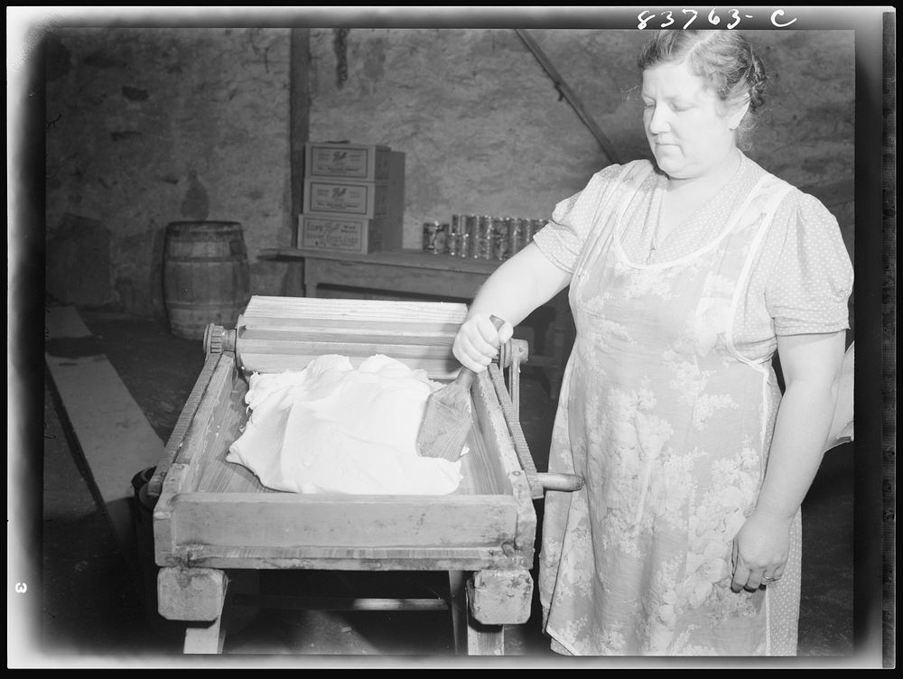 [Fort Kent, Maine (vicinity). Mrs. Gagnon wringing water out of butter after salting]. Sourced from the Library of Congress.