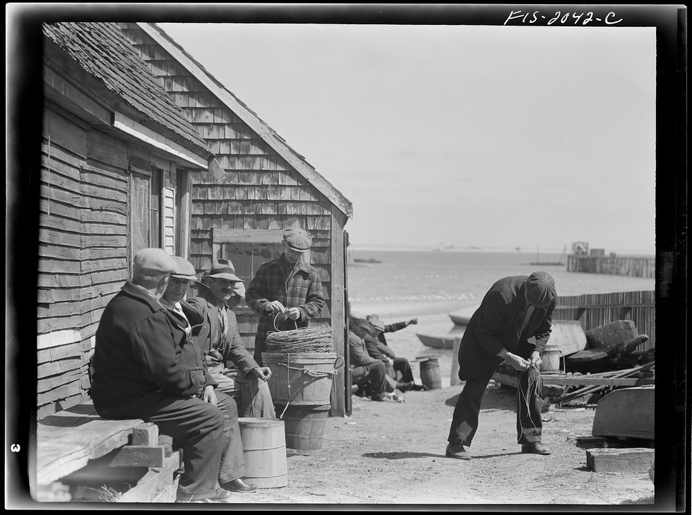 [Untitled photo, possibly related to: Provincetown, Massachusetts. Portuguese dory fisherman coiling down his trawl for the…