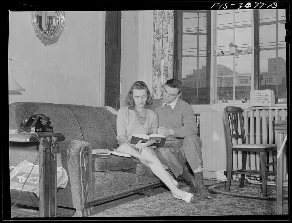 Bob Aden studying with his wife in their apartment. University of Nebraska, Lincoln. Sourced from the Library of Congress.