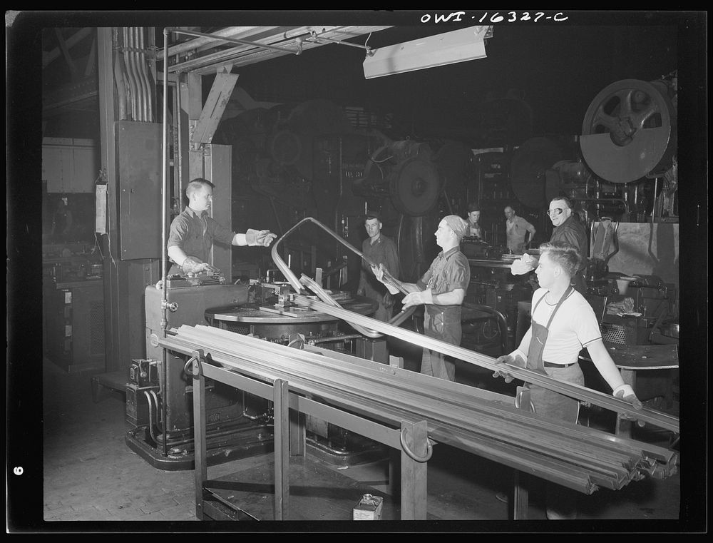Dearborn, Michigan. Workers in the River Rouge Ford plant bending metal strips to form window frames for automobiles.…