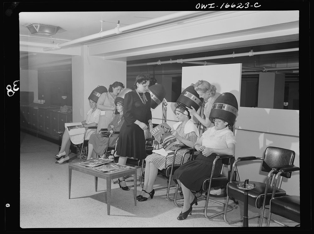 Detroit, Michigan. Women drying their hair in the beauty shop at the Crowley-Milner department store. Sourced from the…