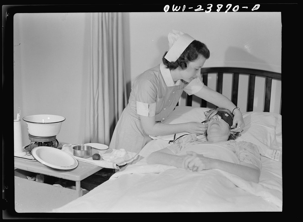 Student nurse, Frances Bullock adjusts an eye shield for a post-operative patient after the dressing has been changed.…