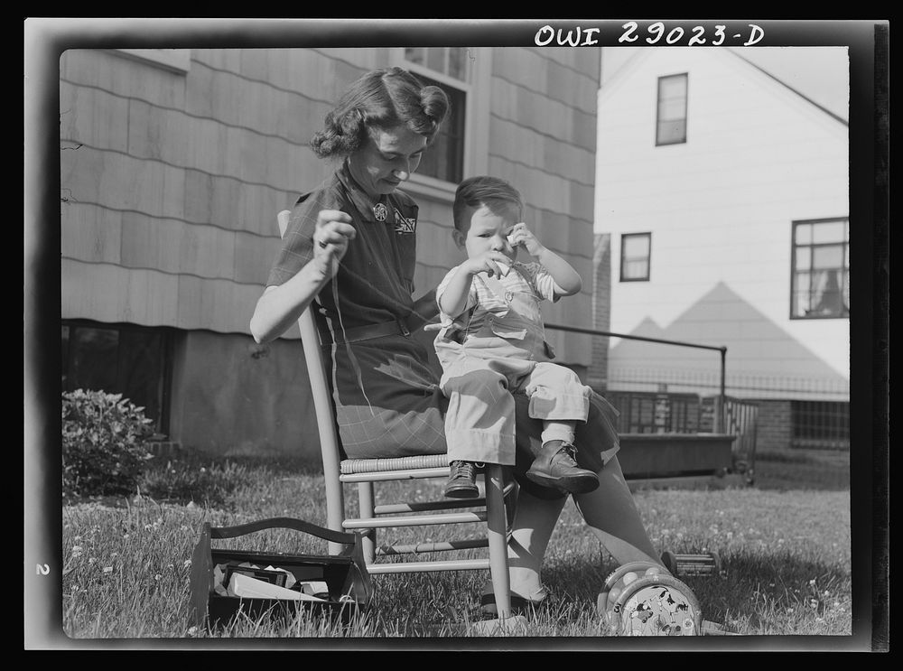 [Untitled photo, possibly related to: A mother sewing a button on her child's overalls. Silver Spring, Maryland]. Sourced…
