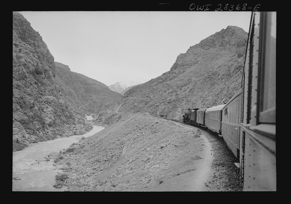 Mountainous route of trains carrying supplies to Russia. An American engine with an American crew along a gorge through the…