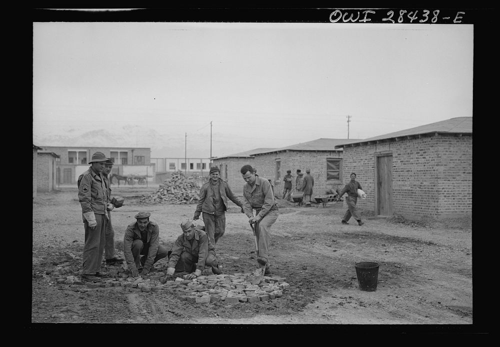 Repairing the road around the billets of American troops who will work at the railroad yard where supplies for Russia pass.…