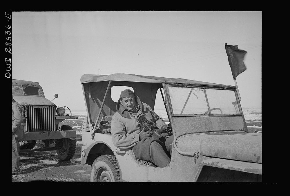 OWI (Office of War Information) photographer Nick Parrino somewhere in the Persian corridor in the Jeep in which he rode to…