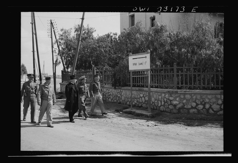 Sfax, Tunisia. Archbishop Spellman walking with American officers in the vicinity of the railway station. Sourced from the…