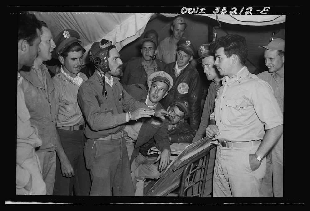 Lieutenant Richard E. Duffey, twenty-four, of Walled Lake, Michigan, giving an account at the 57th Fighter Group base in…