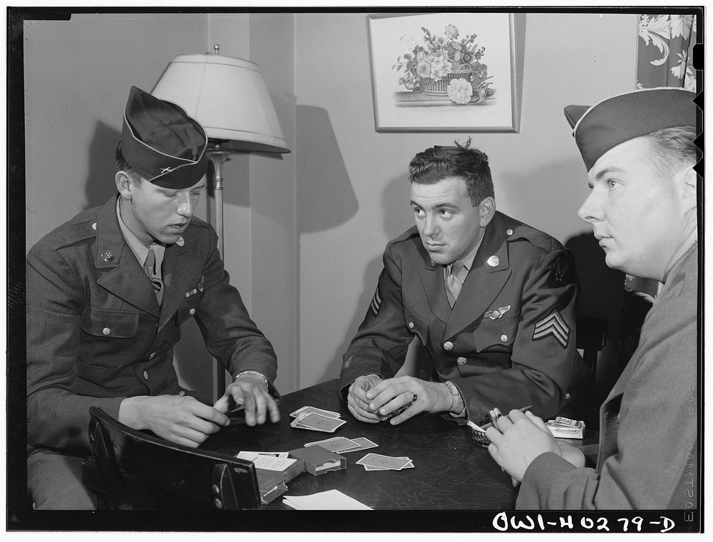 Washington, D.C. Soldiers waiting between trains playing cards in the game room at the United Nations service center.…