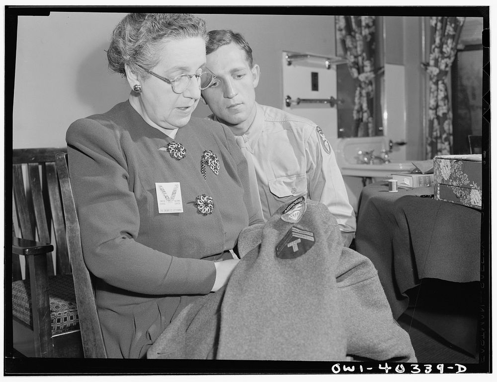 Washington, D.C. A volunteer at the United Nations service center sewing insignia and newly-acquired chevrons on the…