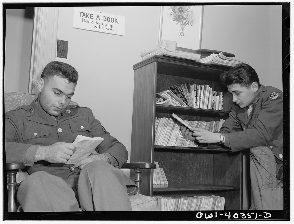 Washington, D.C. In the library at the United Nations service center. Boys are urged to take books back to camp with them.…