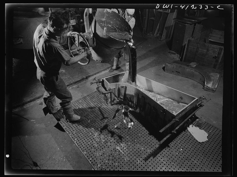 Boeing aircraft plant, Seattle, Washington. Production of B-17 (Flying Fortress) bombing planes. Pouring a lead die to be…