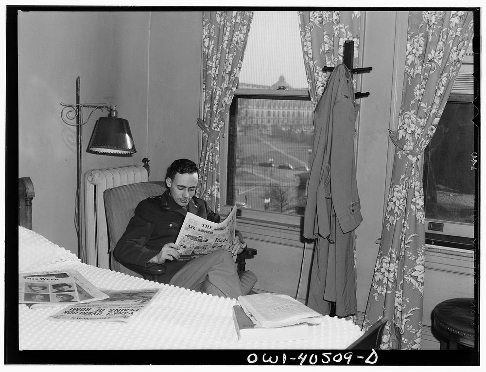 Washington, D.C. A lieutenant in the United States Army Air Transport Command reading the paper in his room at the United…