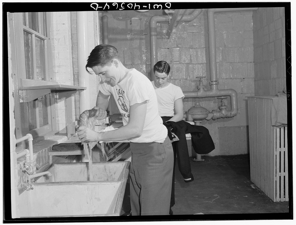 Washington, D.C. Servicemen using the laundry facilities in the sub-basement of the United Nations service center. It is not…