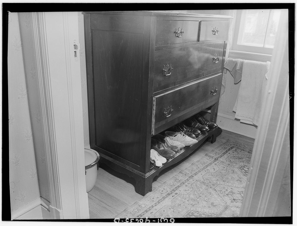 Washington, D.C. Bureau and shoes in the room of Hugh Massman, a second class petty officer who is studying in Washington…