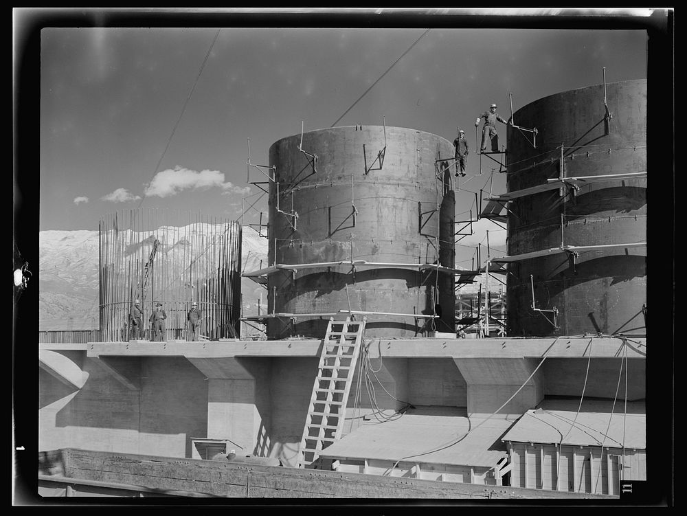 Columbia Steel Company at Geneva, Utah. The erecting crane is kept busy as blast furnaces take form in a new steel mill…