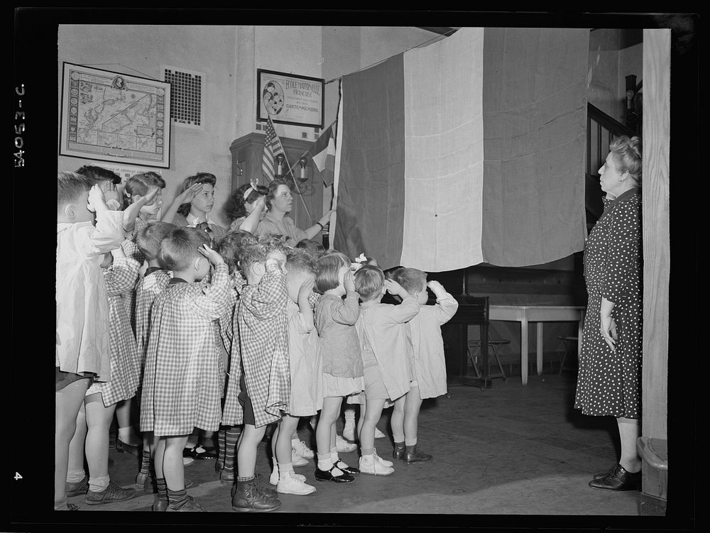 New York, New York. June 6, 1944. Preschool children at L'Ecole maternelle francais on D-day saluting the French flag.…