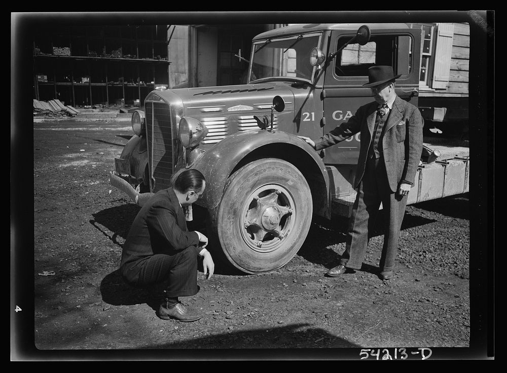 [Untitled photo, possibly related to: Washington, D.C. A Galliher and Huguely, Inc. truck, showing two men looking at one of…
