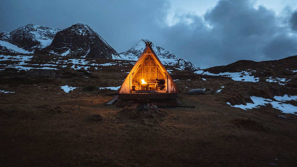 Adventure desktop wallpaper background, fire pit in a wooden hut on Lofoten island, Norway