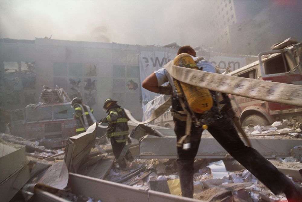 Rescue officer carrying a hose during the aftermath of the September 11 terrorist attack on the World Trade Center, New York…