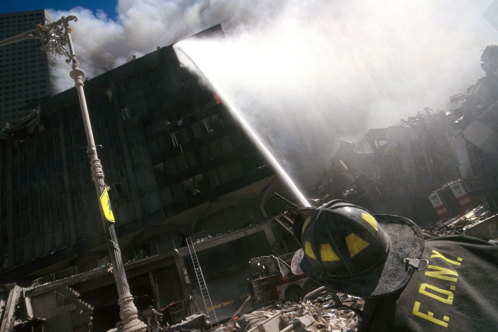 Rescue officers ceasing the fire during the aftermath of the September 11 terrorist attack on the World Trade Center, New…