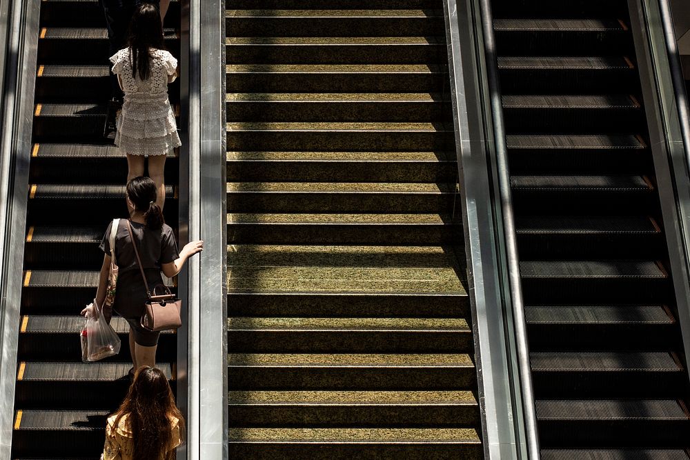 Women on an escalator in the Bangkok subway. BANGKOK, THAILAND, 16 APRIL 2021