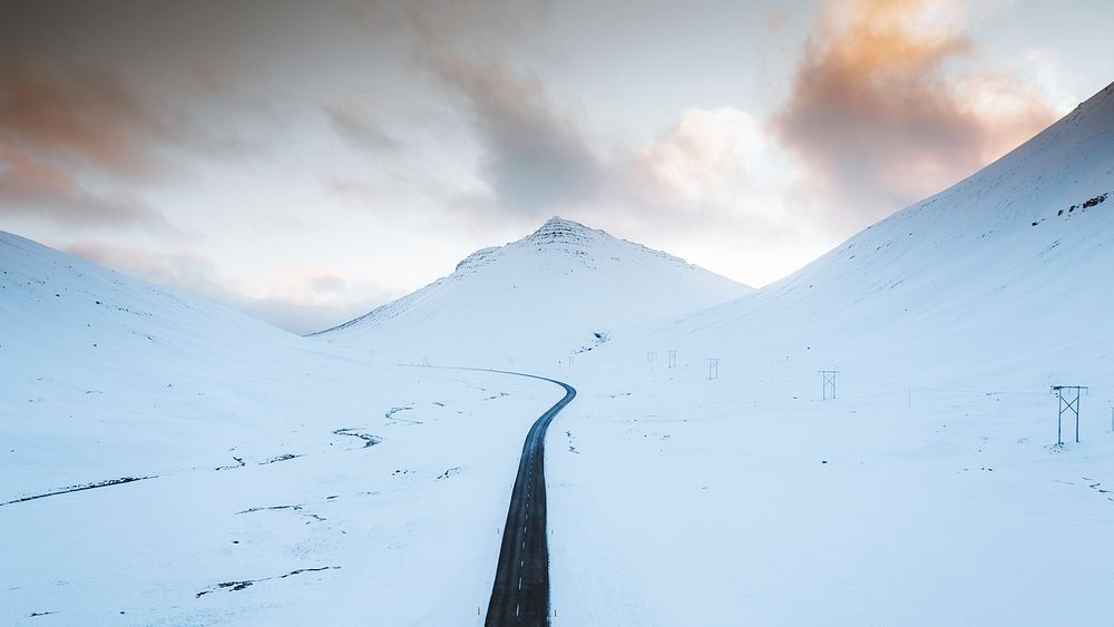 Nature desktop wallpaper background, long black road on the white winter landscape