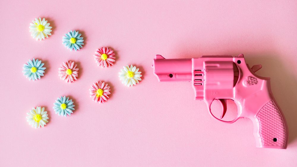 Aesthetic desktop wallpaper, pink background with flower and a gun