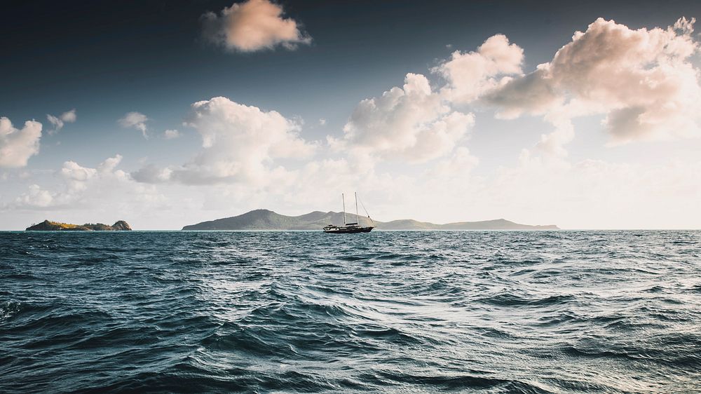 Ocean desktop wallpaper background, sailboat in a blue sea