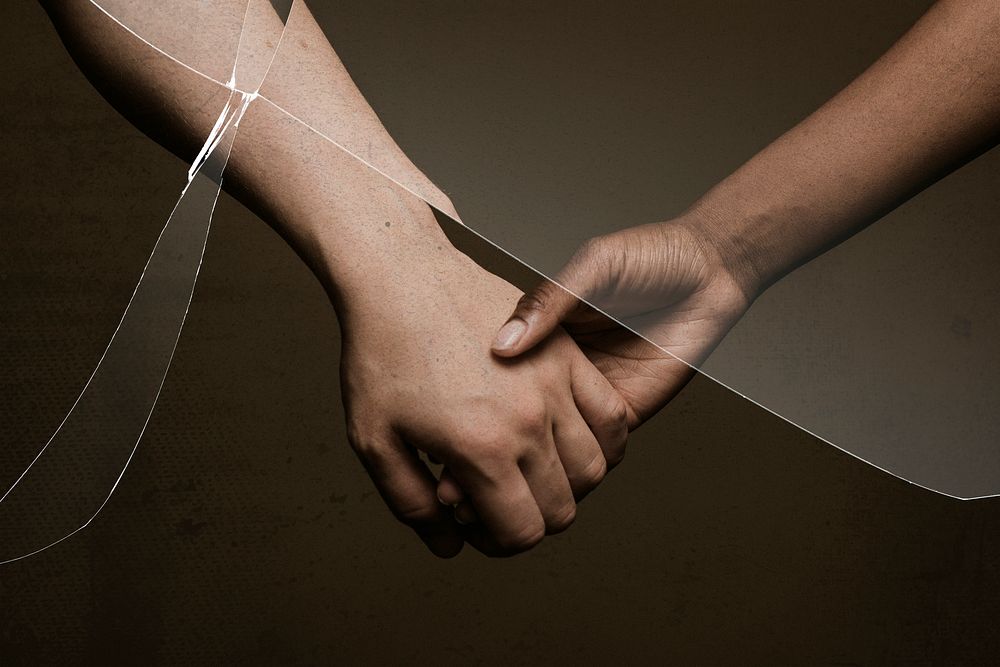 Broken relationship with cracked glass effect and people holding hands behind