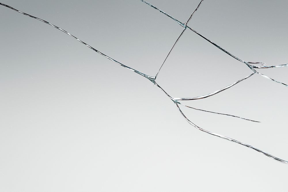 Gray background with cracked glass texture