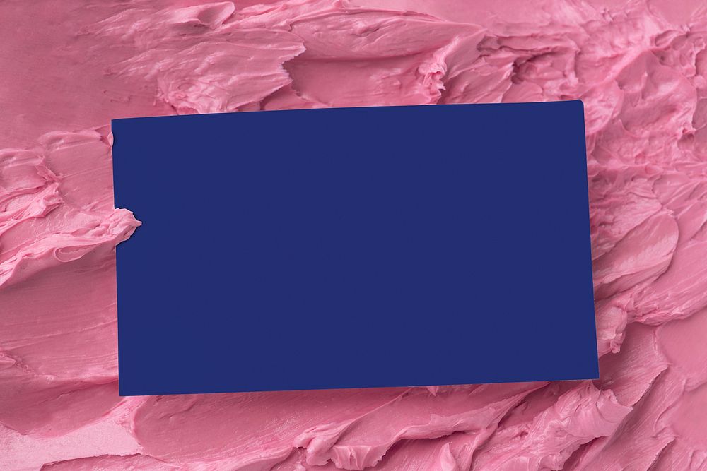 Blue business card on pink frosting texture