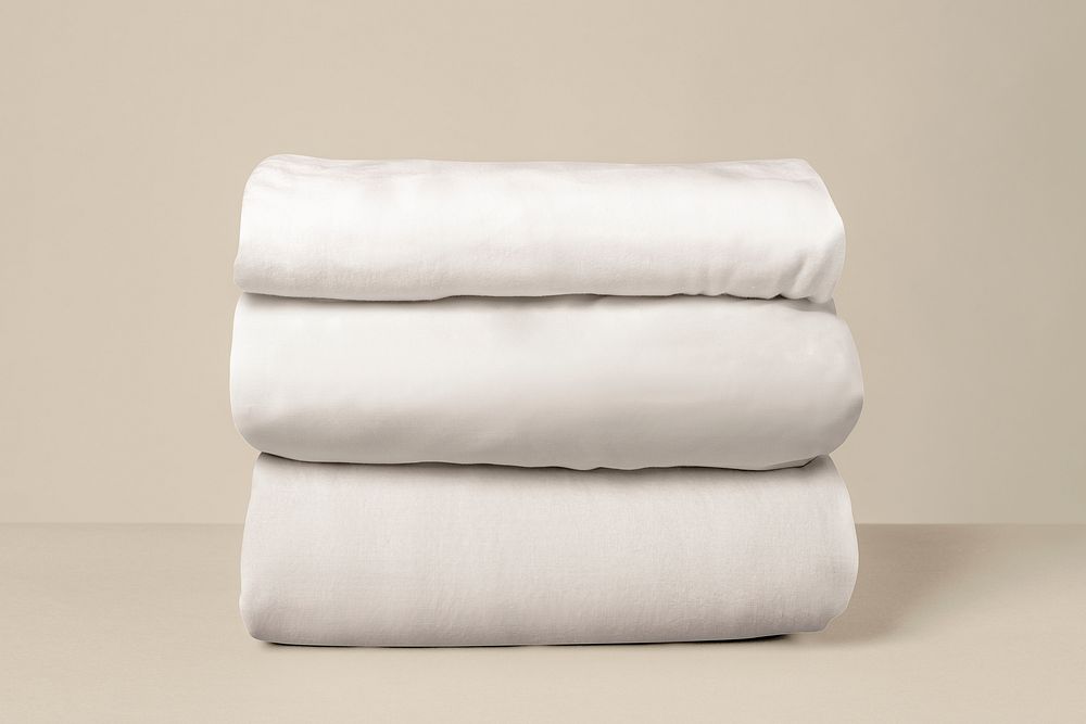 Stacked white bed linen 