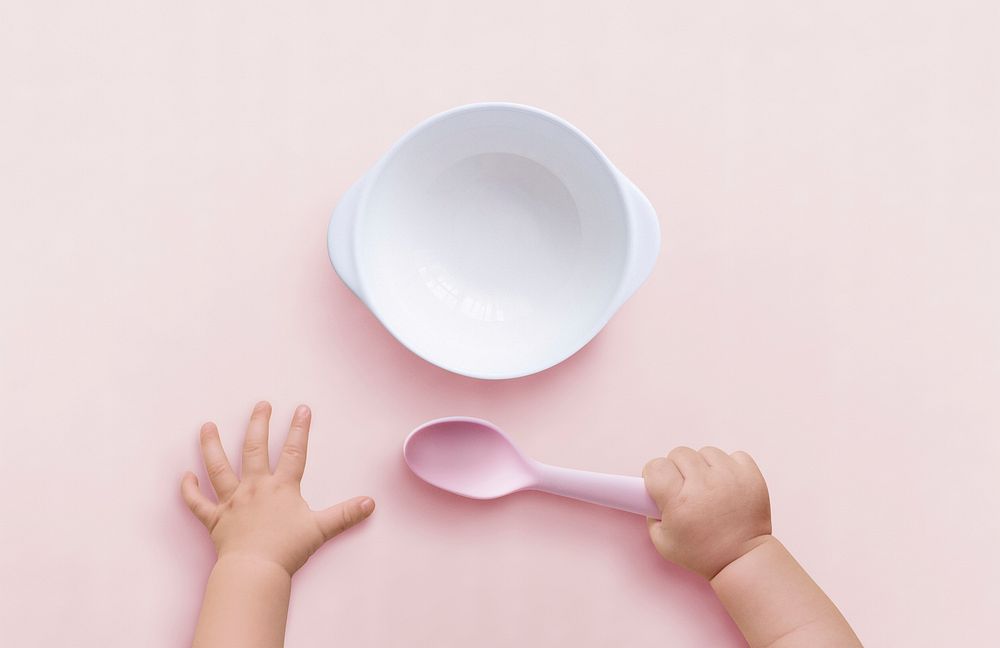 Baby hands background holding spoon pink plastic image