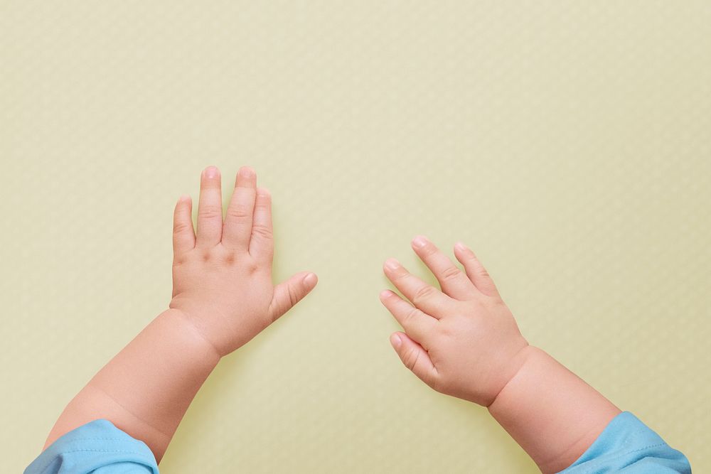 Cute baby hands psd background in green